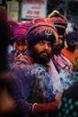 Colorful Sikh men celebrate Holi festival through traditional attire and rituals.